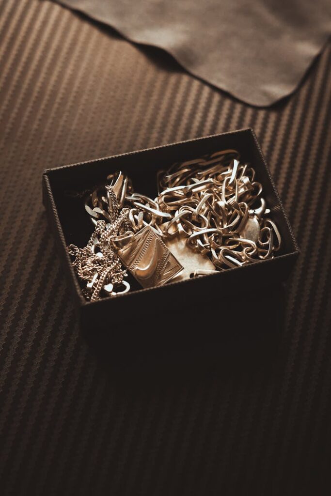 Luxurious gold chains elegantly placed inside a black jewelry box.